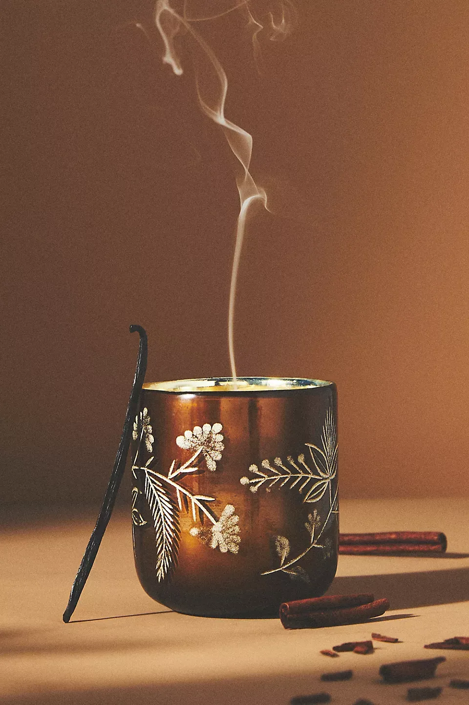 Engraved floral pattern on amber glass