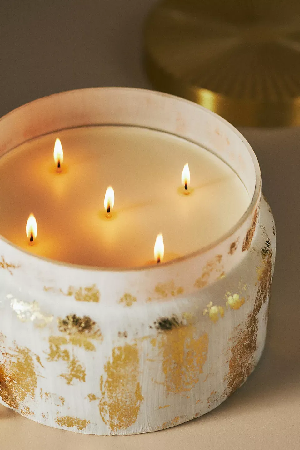 Glass candle vessel with hand-applied gold leaf